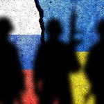 Silhouettes against split Russian and Ukrainian flags