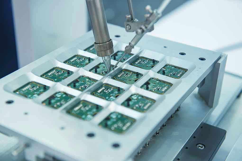 Robotic arm assembling electronic circuit boards in production