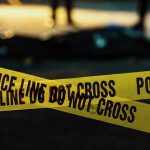 Police tape marking a crime scene at night