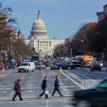 People crossing street near the US Capitol building