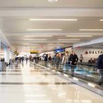 People walking through a busy airport terminal