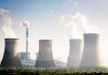 China’s Strategic Sabotage EXPOSED — Energy War Four cooling towers of a power plant emitting steam