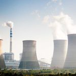 Four cooling towers of a power plant emitting steam