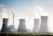 China’s Strategic Sabotage EXPOSED — Energy War Four cooling towers of a power plant emitting steam