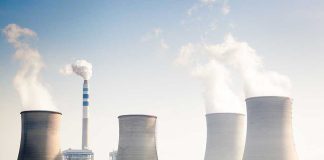 China’s Strategic Sabotage EXPOSED — Energy War Four cooling towers of a power plant emitting steam