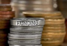 Trump Freezes $700 Million—Red States Stunned Stack of coins labeled funding with other coins stacks