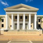 Exterior view of the Supreme Court of Florida with columns and palm trees