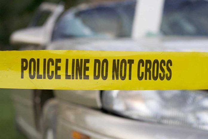 shutterstock_3358598.jpg Yellow police tape reading POLICE LINE DO NOT CROSS in front of a vehicle