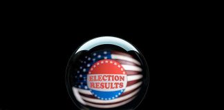 Election Results button hovering over outstretched hand