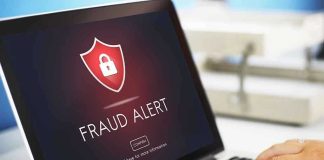 Laptop displaying fraud alert warning on screen