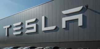Tesla facility with parked cars in front