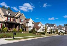 Trump Torches “Woke” Housing Rules—Stuns Experts A row of modern suburban houses under a clear blue sky