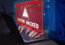 Warning sign System Hacked on laptop screen.