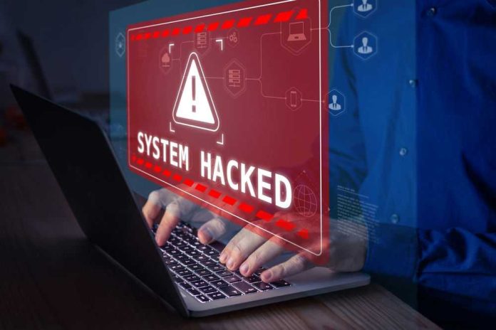 Warning sign System Hacked on laptop screen.
