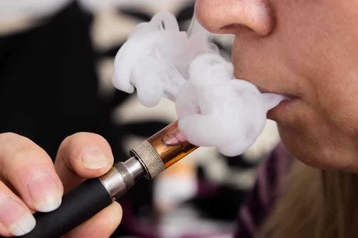 Close-up of a person vaping, exhaling smoke clouds