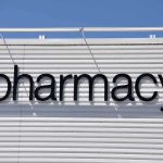 Sign displaying the word pharmacy against a white background