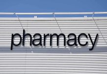 Sign displaying the word pharmacy against a white background