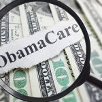 Magnifying glass over Obamacare text and money