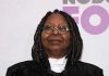 Epstein Files Frenzy Targets Whoopi Goldberg Person with dreadlocks and round glasses, smiling slightly.