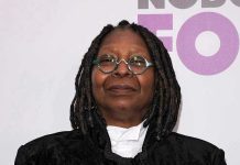 Epstein Files Frenzy Targets Whoopi Goldberg Person with dreadlocks and round glasses, smiling slightly.