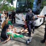 Protesters block bus believed to be carrying Iran women's