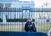 Gunfire Erupts at White House – Chaos Unleashed! Secret Service agent stands guard outside the White House.
