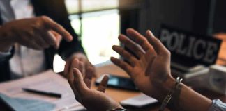 Person handcuffed in discussion with another person