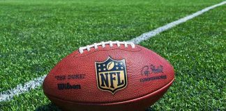 NFL Star’s $197M Scam Targets Seniors NFL football on a green field.