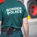 Person in Border Police uniform standing outdoors.