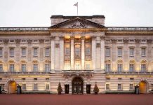 Royal Probe EXPANDS—Explosive Prince Andrew Allegations Front view of Buckingham Palace with illuminated facade and British flag