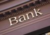 Trump’s Banking Order STUNS—Citizenship Now Key Close-up of a bank sign with gold lettering