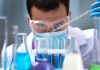 Measles Alert Hits Sewers — Then What? Scientist pipetting blue liquid into test tubes.