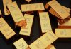 Dollar Dominance Tested — What Changed? Gold bars stacked on dark background