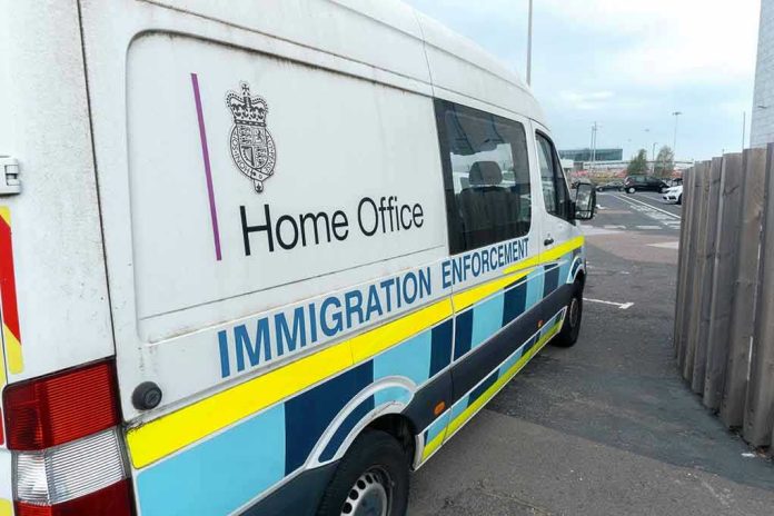 2212785583-1 White immigration enforcement van parked by roadside