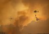 Governor Sounds Alarm: ‘Not a Normal Fire’ Helicopters dropping water over forest fire smoke sky