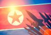 North Korea Claims Nuclear Output Doubled — While Building More Factories North Korean flag with missile silhouettes.