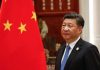 China Claims To Support Denuclearization—So Why The Silence In Pyongyang? A political leader standing beside the Chinese national flag