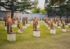 A Grave Desecration Claim Went Viral—But The Evidence Is Surprisingly Thin A memorial site with numerous sculptures and flowers in a grassy area