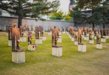 A Grave Desecration Claim Went Viral—But The Evidence Is Surprisingly Thin A memorial site with numerous sculptures and flowers in a grassy area