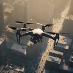 A drone flying over a cityscape during sunset