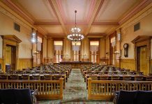 The Democrat Fundraising Platform That Lost Its Entire Legal Team Interior view of a historic courtroom with wooden furnishings and chandeliers