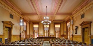 The Democrat Fundraising Platform That Lost Its Entire Legal Team Interior view of a historic courtroom with wooden furnishings and chandeliers