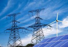 Can Europe Ignore Trump’s Warning? Power lines, solar panels, and wind turbine against sky.