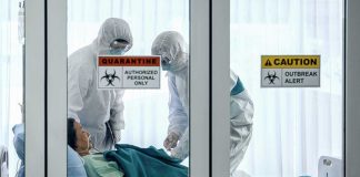 Quarantine Power Flex Stuns Nebraska Healthcare workers in protective gear in quarantine room.