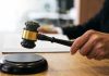 Court Refuses To Return Christian-Born Teen Flag of Pakistan waving in a blurred urban background
