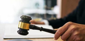 Court Refuses To Return Christian-Born Teen Flag of Pakistan waving in a blurred urban background
