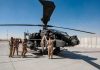 Jordan Strike Lights Fuse—What Follows? Soldiers inspect a military attack helicopter on a tarmac
