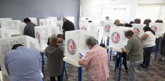 Election Blue Line Crossed In California? Voters fill out ballots at polling booths in a busy voting room
