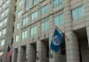 Unchecked ICE Patrols Spark Panic U.S. government building facade with American and blue departmental flags