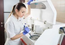 Carbon Dioxide Cure—or Disaster? Lab technician using an analyzer with a pipette